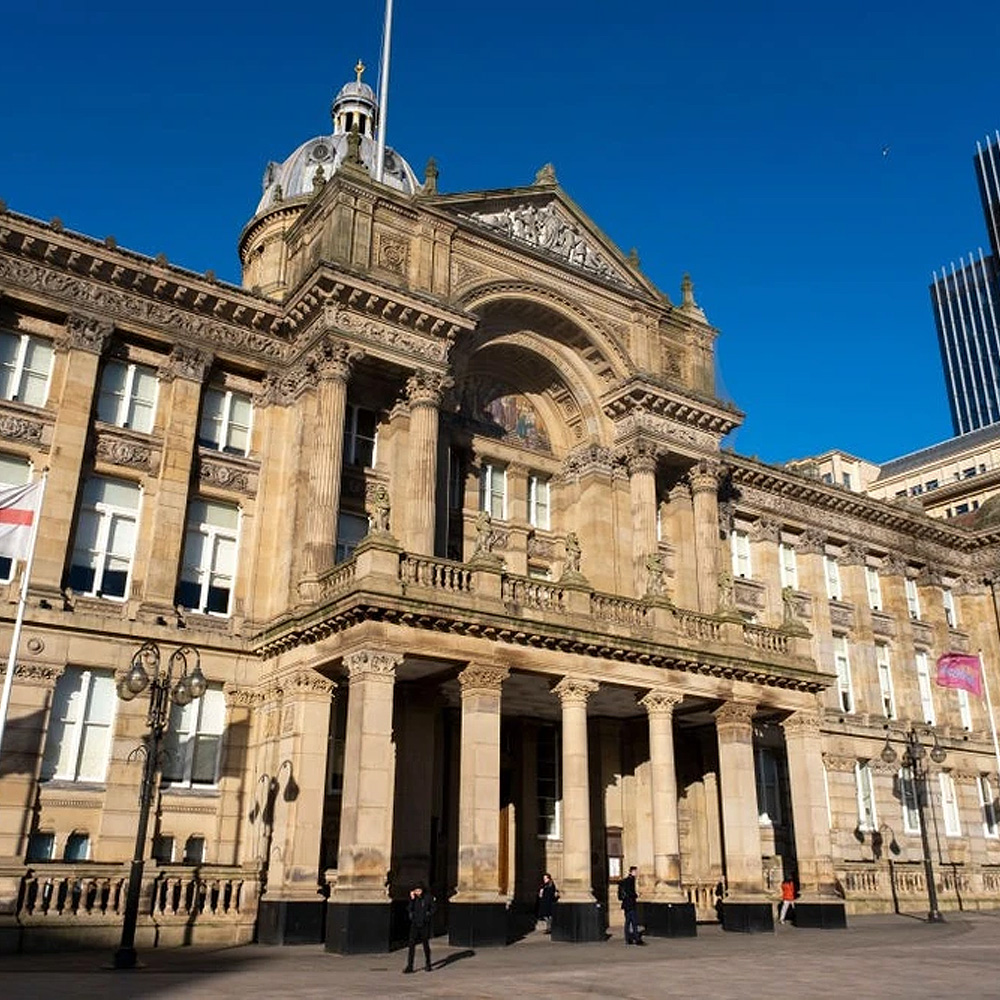 An old building exterior with classic architecture columns and archways