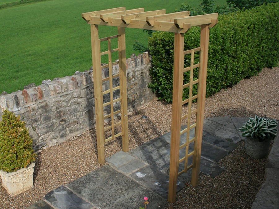 A contemporary wooden Avon Garden Arch product situated in a garden and placed between a slabbed walkway