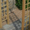 A close up image of the square side trellis details of the wooden Avon Garden Arch product