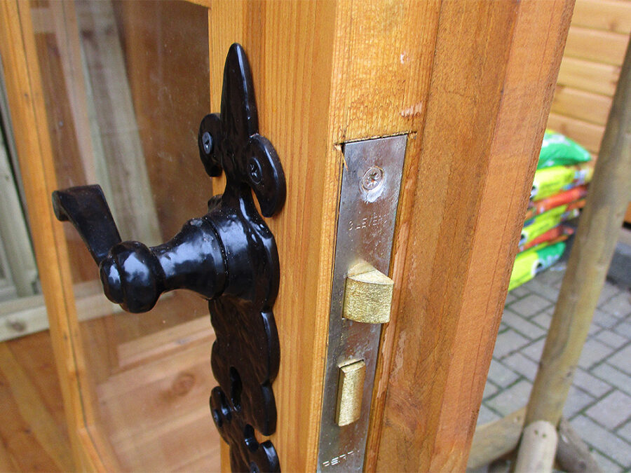 A close up image of the door and lock mechanism on a wooden Contemporary Summerhouse