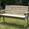 A Hutton Dean 3 Seater wooden garden furniture in a grassy section next to bushes
