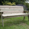 A Hutton Dean 3 Seater wooden garden furniture in a garden setting