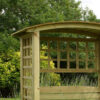 A close up image of the curved roof top, and square side trellis details of the wooden Northwood Arbour product