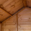The interior of a Rutland Sheds Playhouse, showcasing the beams and fittings to provide a dry and safe environment for children's play