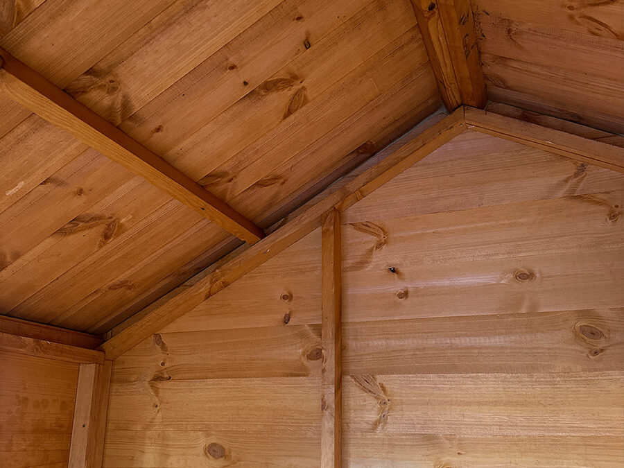 The interior of a Rutland Sheds Playhouse, showcasing the beams and fittings to provide a dry and safe environment for children's play