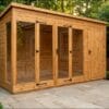 Contemporary summerhouse exterior showing full-width bifold glass doors and timber side storage section, set against a brick wall – Rutland Sheds